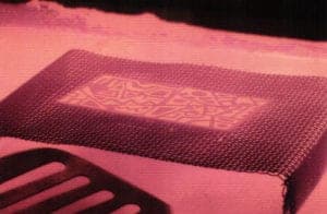 Firing the enamel design onto the metal.